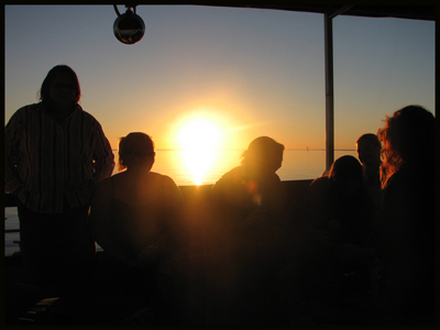 people watching the sunset over the gulf of carpenteria